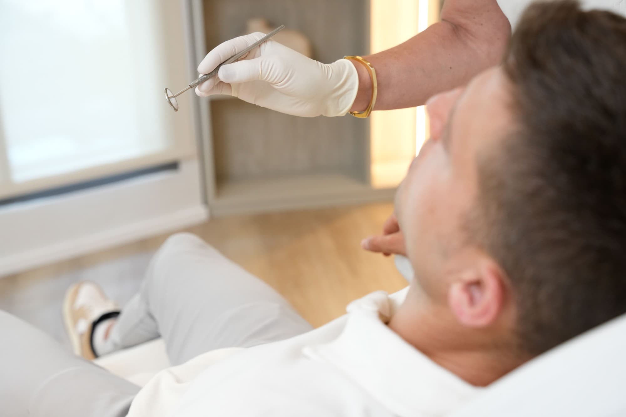 Clinician performing a chairside oral assessment on a patient